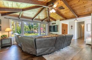 a living room with a couch and a ceiling fan at Starry Pines- Hot Tub in Yosemite Forks