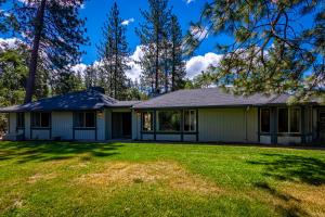 a house with a lawn in front of it at Starry Pines- Hot Tub in Yosemite Forks