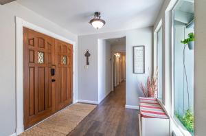 a hallway with a wooden door and a chair at Starry Pines- Hot Tub in Yosemite Forks +38 photos