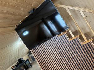 einen großen Flachbild-TV, der von einer Wand hängt in der Unterkunft Casa Ionuț și Sofia in Podu Dîmboviţei