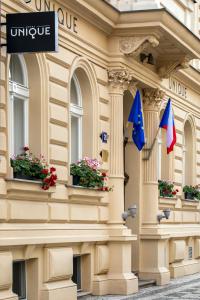 a building with two flags and flowers on it at Hotel Unique in Prague