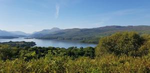 a view of a river with mountains in the background at Anchorage Accommodation in Balloch