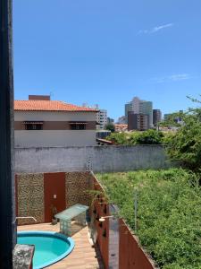 a view from the balcony of a house with a swimming pool at Pousada e Hostel Ponta de Campina in Cabedelo
