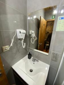 a bathroom with a sink and a mirror at Refúgio Rural no Gerês - Casa Araujo de Sousa in Terras de Bouro