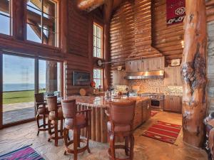 a kitchen with a table and chairs in a cabin at LX28: Gold Beach Oceanfront Estate in Ophir
