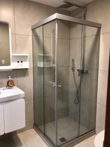 a shower with a glass door in a bathroom at Spacious, modern brand new apartment 22 best location in La Paz