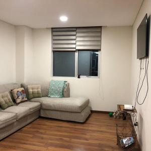 a living room with a couch and a television at Spacious, modern brand new apartment 22 best location in La Paz