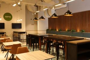 a restaurant with tables and chairs in a room at Casa Andina Standard Benavides in Lima