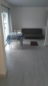 a living room with a table and a couch at Buga home in Buga