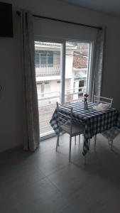 a table and a chair in a room with a window at Buga home in Buga