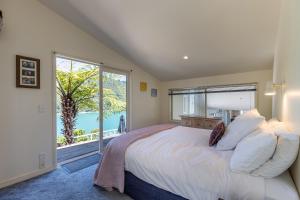 a bedroom with a bed and a large window at Portage Bay Hub in Portage