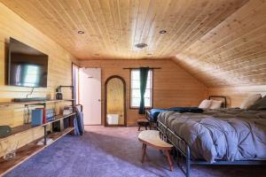 a bedroom with a bed and a wooden ceiling at Captain's Cabin in Burnsville