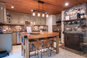 a kitchen with a wooden island in the middle at Captain's Cabin in Burnsville