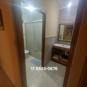 a bathroom with a shower and a toilet and a sink at Casita de la playa in La Lucila del Mar