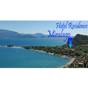 a view of a beach with boats in the water at Residence Miralago Rooms & Apartments in Manerba del Garda