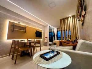 a living room with a couch and a table at Kauai Beach Residence 403 in Tamandaré