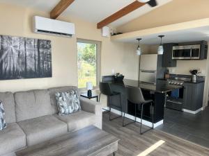 a living room with a couch and a kitchen at One Night with the Stars in Arroyo Seco