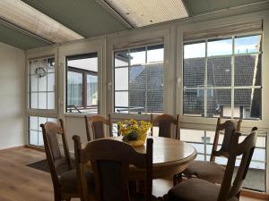 een eetkamer met een tafel, stoelen en ramen bij Casaba Suite 2-150qm-4 Rooms-Free Private Parking-House with garden in Hannover