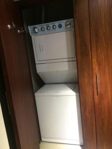 a white stove and a refrigerator in a cabinet at Torre Bellini in Guayaquil