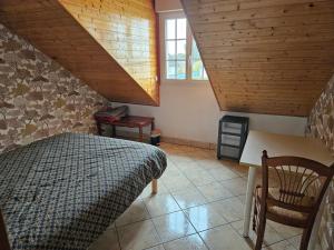 a bedroom with a bed and a wooden ceiling at Maison Sérénité in Lailly-en-Val +13 photos
