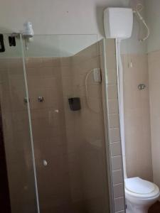 a bathroom with a shower and a toilet at Chalé Dedo de Deus in Guapimirim +12 photos