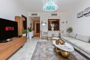 a living room with a couch and a tv at Downtown Zaafaran 2, in Dubai