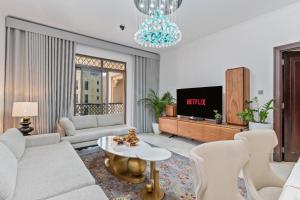 a living room with a couch and a tv at Downtown Zaafaran 2, in Dubai