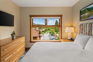 a bedroom with a bed and a large window at WorldMark Chelan - Lake House in Chelan +32 photos