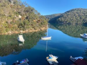 three boats are docked in the water next to an island at Dreamtime Bay 