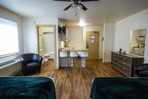 a room with a sink and a bathroom at Sleep Suite Motel in Steinbach +116 photos