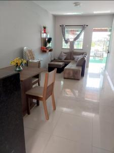 a living room with a couch and a table at Cantinho da família in Araruama