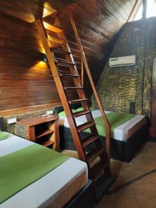 A bed or beds in a room at Cinnamon Leaf Leisure Resort Lake view Cabana