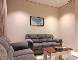 a living room with a couch and a table at فندق جراند جرين in Jazan +13 photos