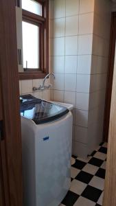 a small kitchen with a sink and a stove at Apto Vista Incrivel 7 pess in Bento Gonçalves +21 photos