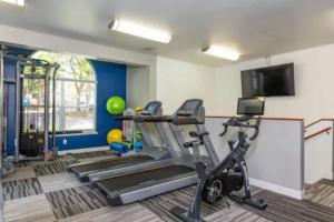 a fitness room with a gym with tread machines at The Study, a Summer Retreat in Corvallis