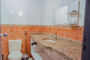 a bathroom with a sink and a toilet and a mirror at Chalé por do Sol in Aracaju +60 photos