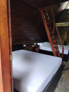 A bed or beds in a room at Cinnamon Leaf Leisure Resort Lake view Cabana