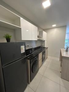 una cucina con frigorifero nero e lavastoviglie di Home Herrera ad Asunción