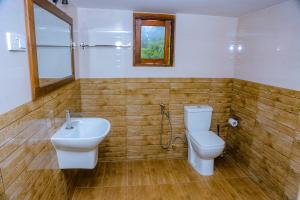 a bathroom with a toilet and a sink at Samasta Inn in Weligama +32 photos