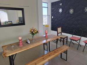 a dining room with a table and chairs and a mirror at Apartamento in Arequipa