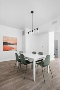 a white dining room with a white table and chairs at Full Duplex Retreat-Two Homes Near Eastside- Family Friendly in Indianapolis +23 photos