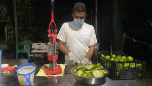 a man wearing a mask preparing food on a table at Apartment near the Río Niño in Upala +36 photos