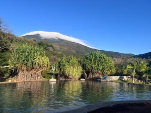 a body of water with a mountain in the background at Apartment near the Río Niño in Upala