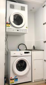 a washer and dryer in a kitchen with a washing machine at Minimalist Studio Escape 31506-2 in Brisbane