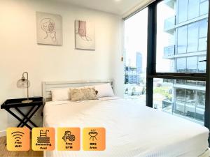 a bedroom with a bed and a large window at Minimalist Studio Escape 31506-2 in Brisbane +10 photos