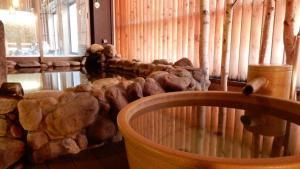 a room with a pile of rocks and a table at Dormy Inn Premium Otaru in Otaru +50 photos