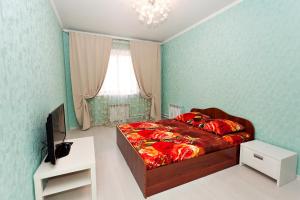 a bedroom with a bed and a television in it at Apartment Grand Kazan on Chistopolskaya 71 in Kazan
