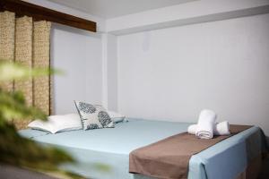 a room with a blue bed and a window at Seaview Apartments in Korotogo
