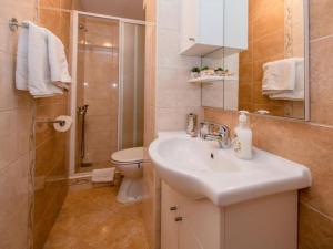 a bathroom with a sink and a toilet and a shower at Apartments Scerbe Gordana & Miljenko Rab - One Bedroom Apartment with Terrace 3 in Otok Rab +13 photos