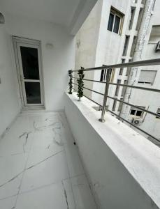 a balcony of a building with plants on it at Seaside 1 min From Beach & Train Station in Tangier
